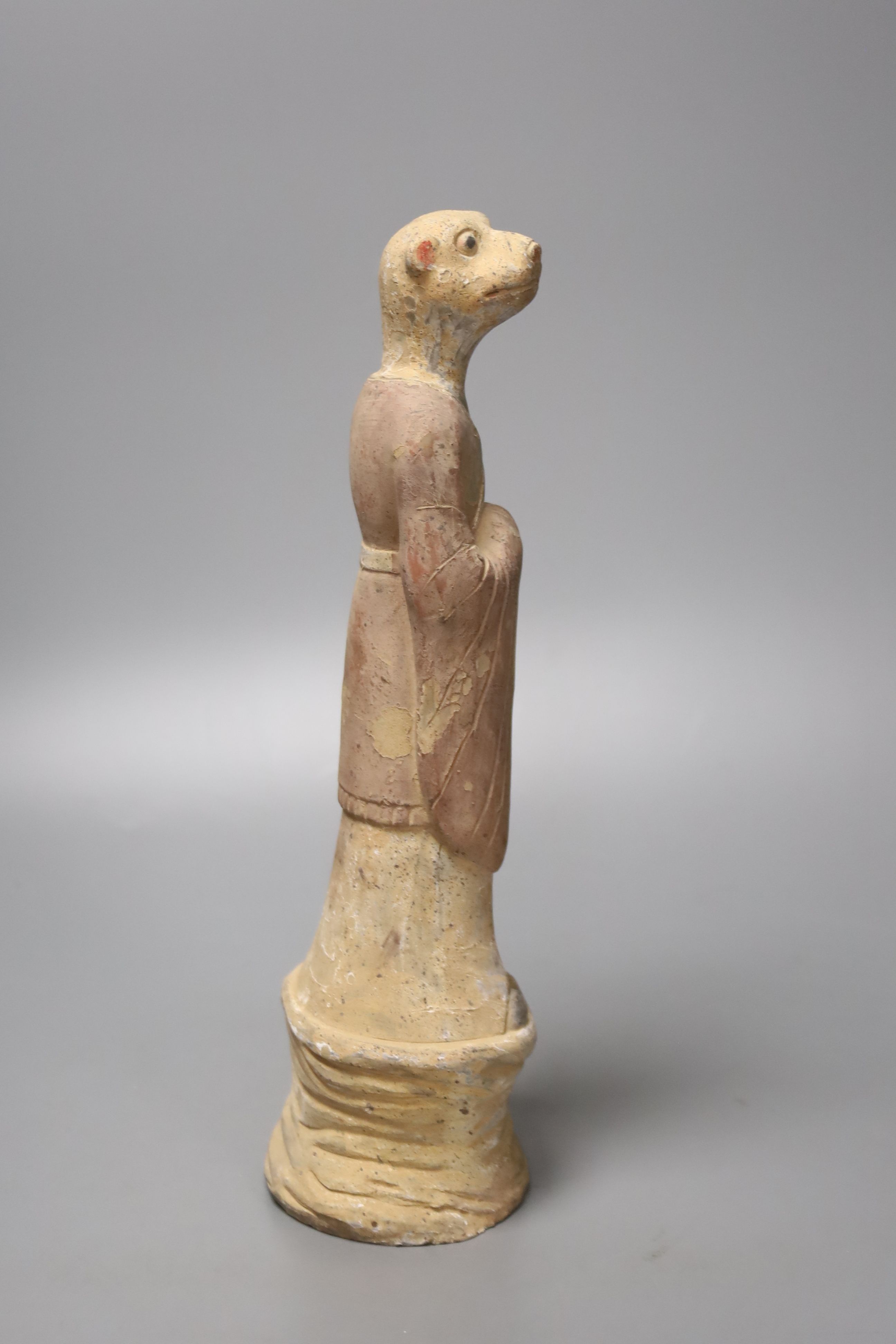 A Chinese tomb pottery zodiac figure of a dog, Han dynasty or later, 28cm high